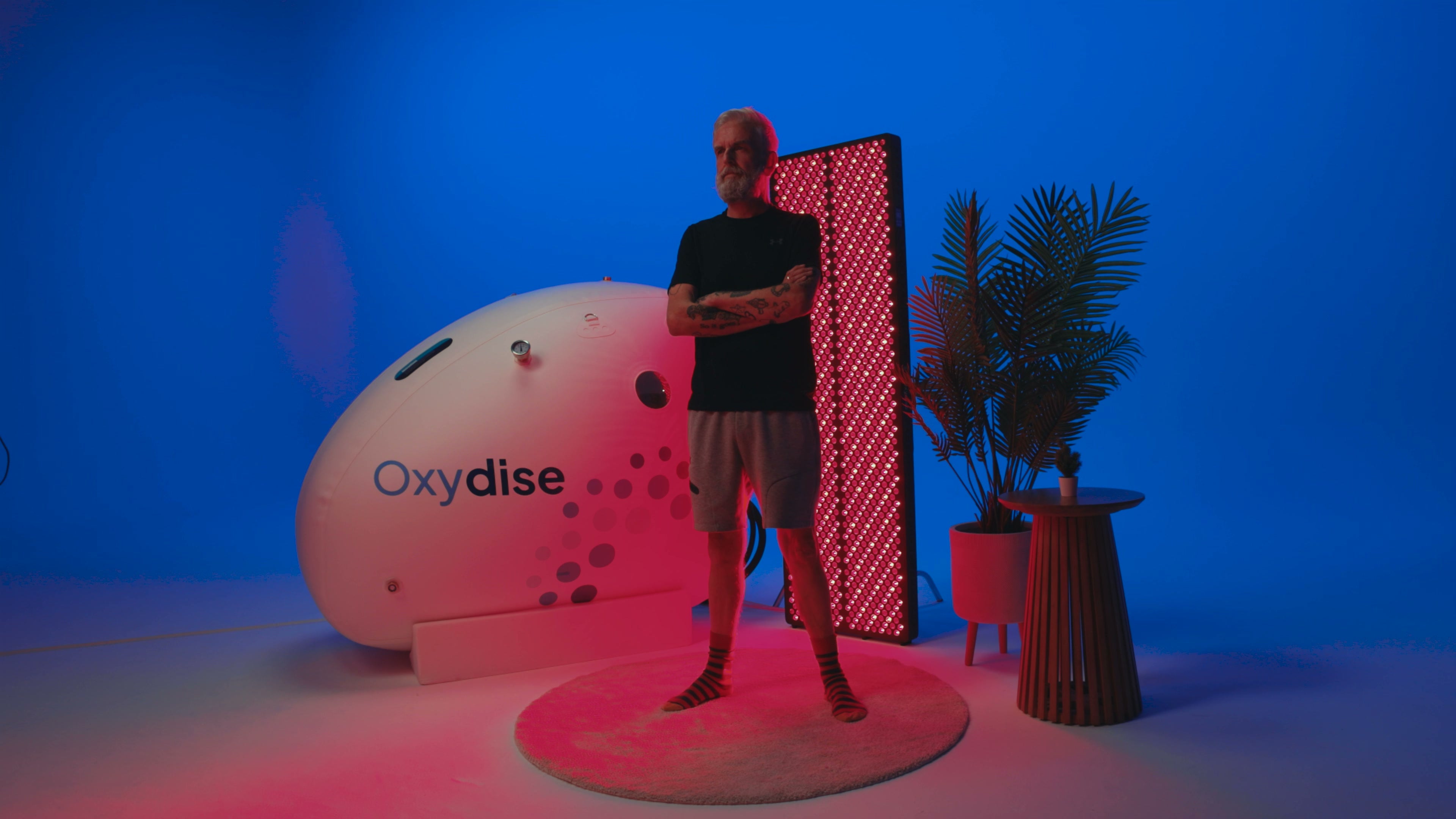 A customer using an Oxydise Red Light Therapy panel